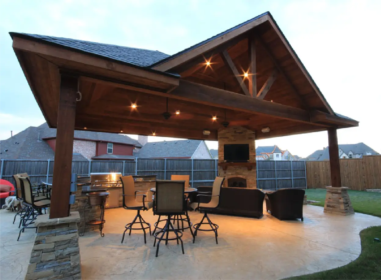 Outdoor barbecue area with wooden canopy.