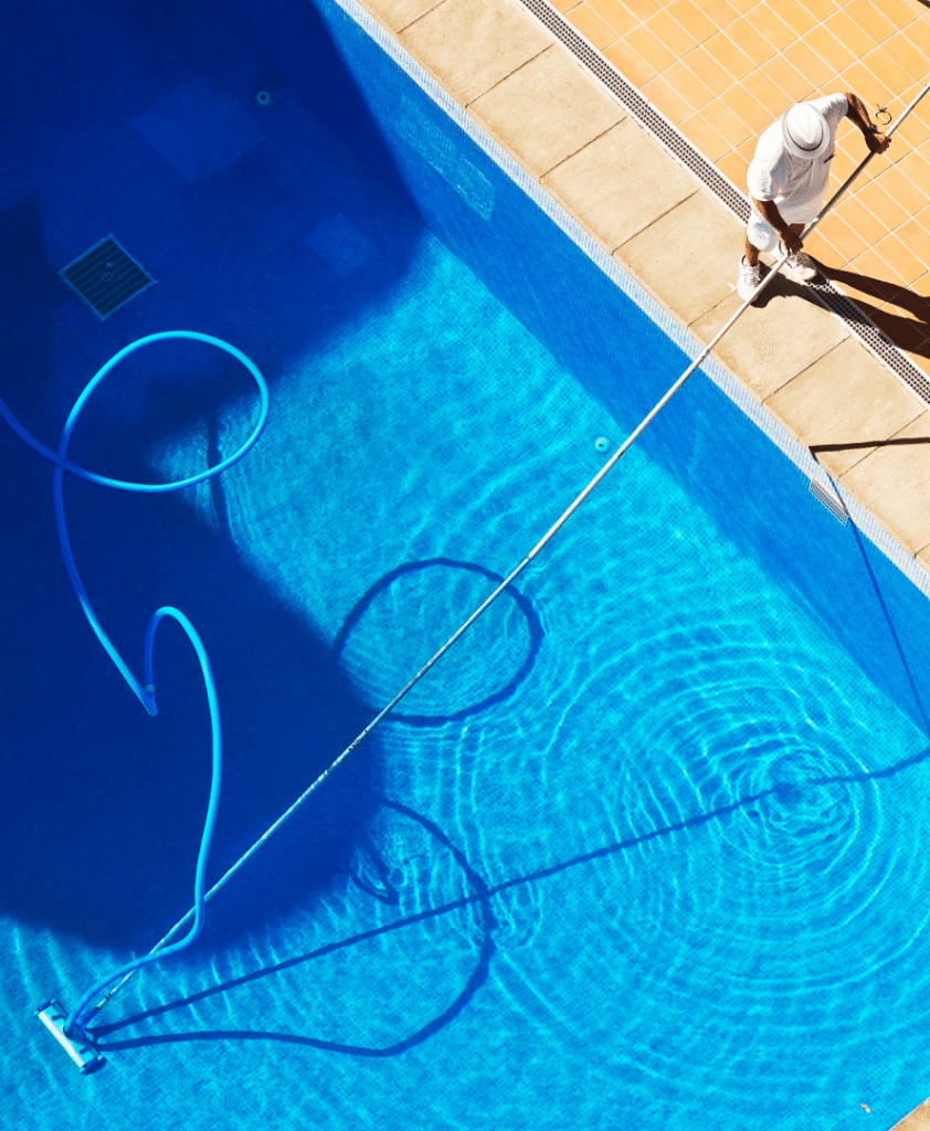 Man cleaning pool.