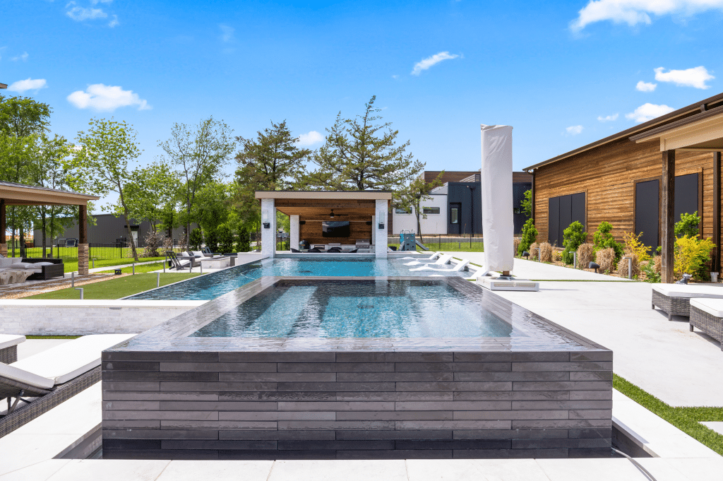 Geometric pool with sun chairs.