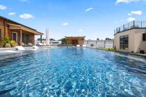 Geometric pool with sun loungers, view from pool.