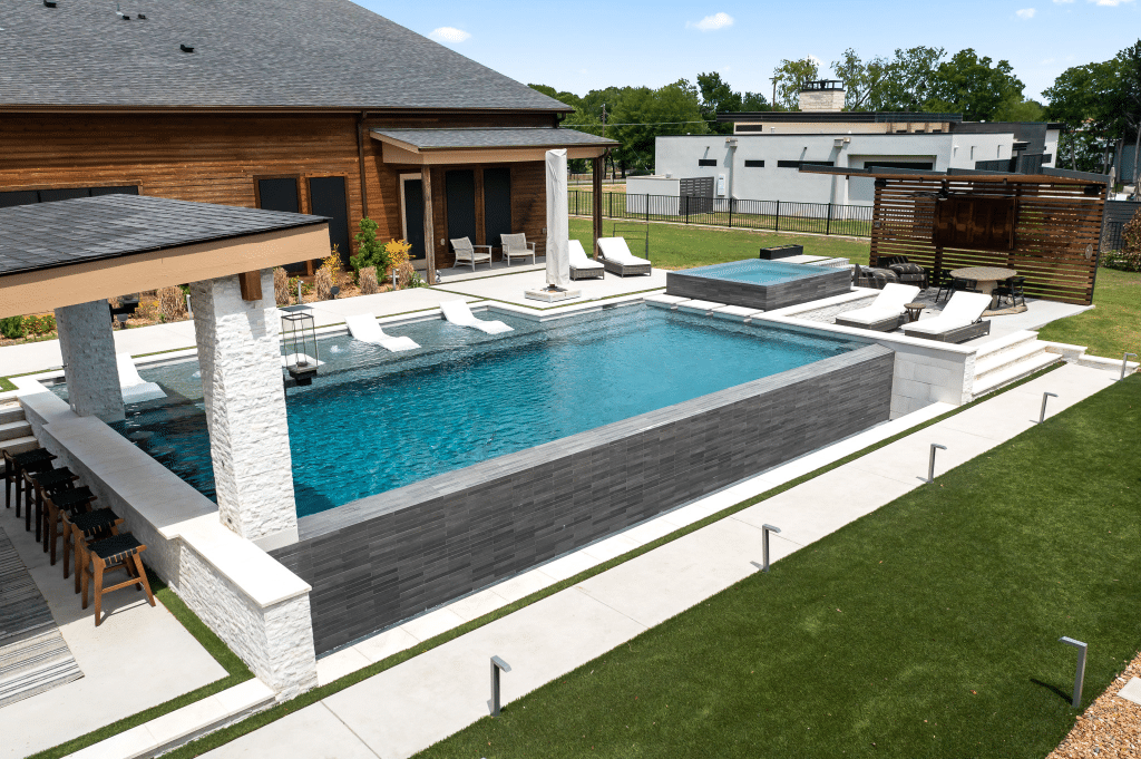 Geometric pool with sun loungers zoomed out view.