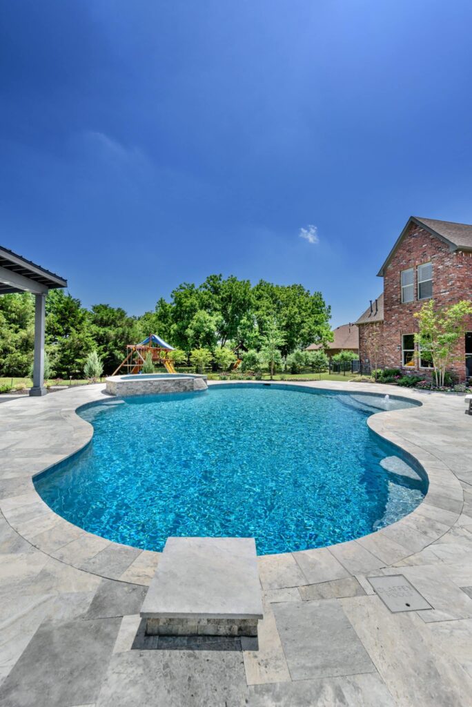 Circular pool outside a brick house