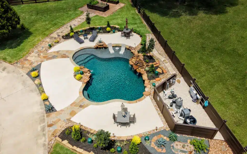 Freeform Pools 1 Aerial view of an outdoor pool and sitting area