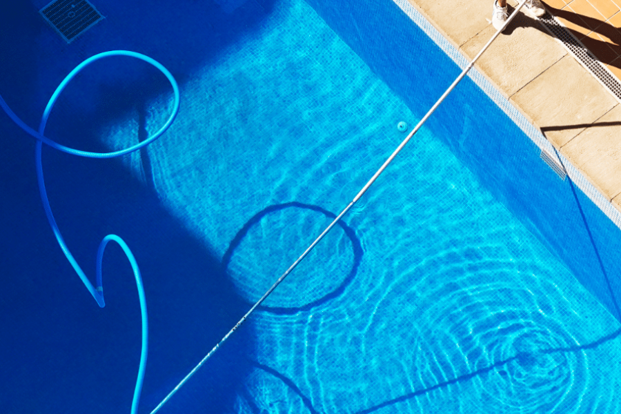 Man cleaning pool.